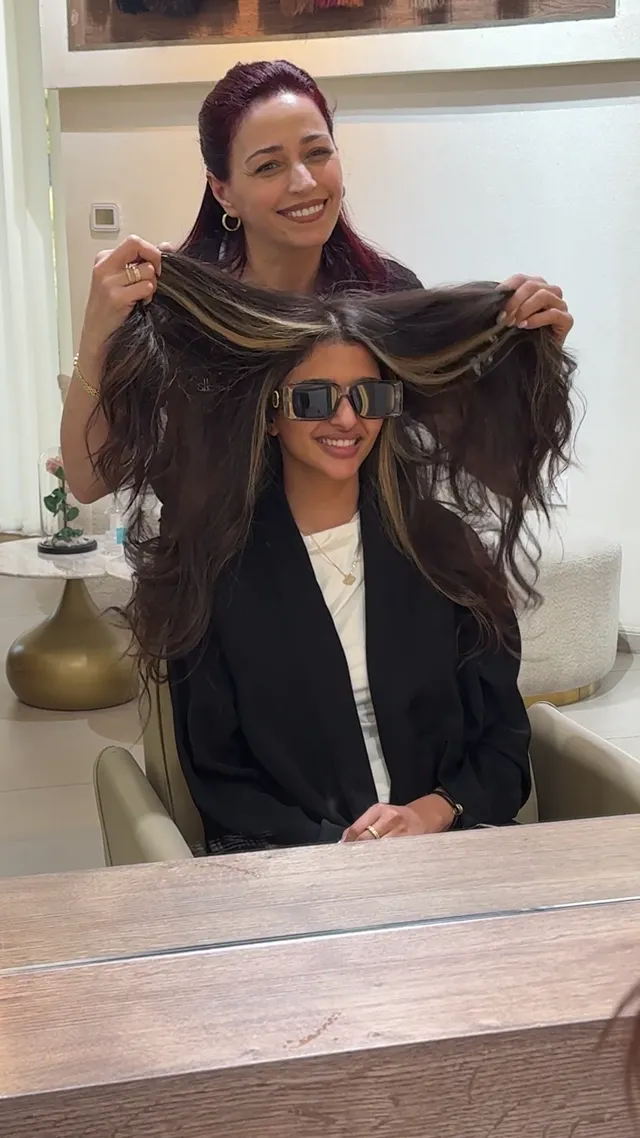 Long hair extensions lifted to show the length