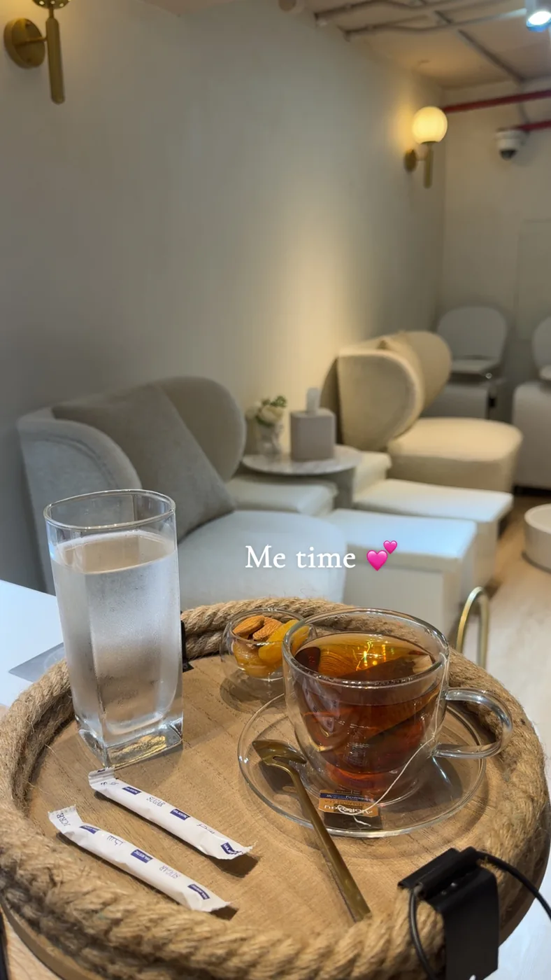 Glass of tea and a glass of water on a round tray in a lounge