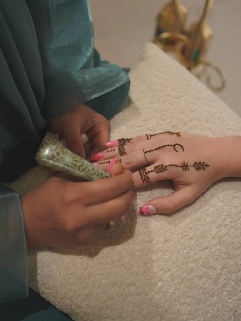 Henna art being applied